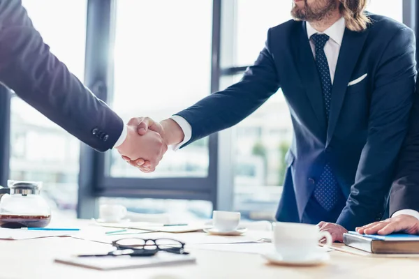 depositphotos_166639502-stock-photo-businessmen-shaking-hands